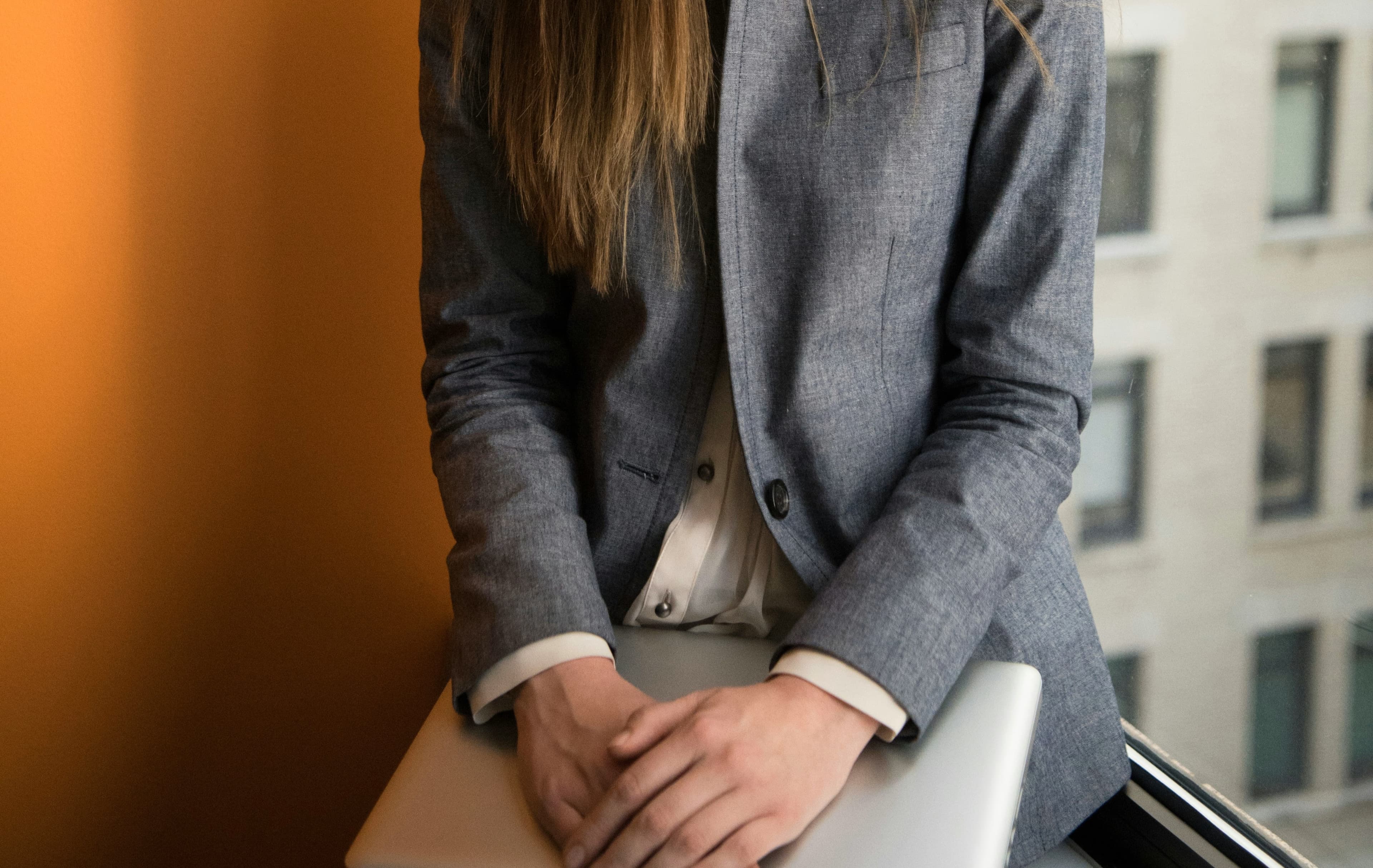 Sales professional holding a laptop in a modern office ready to configure AI features in CRM